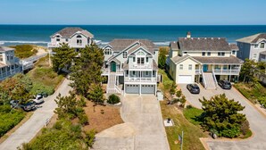 A coastal residential area with houses featuring front porches and a view of the ocean. - Favorite Place: Oceanfront, Private Pool, Spa (Nags Head)