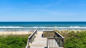 A wooden boardwalk leading to a beach with a clear view of the ocean. - Favorite Place: Oceanfront, Private Pool, Spa (Nags Head)