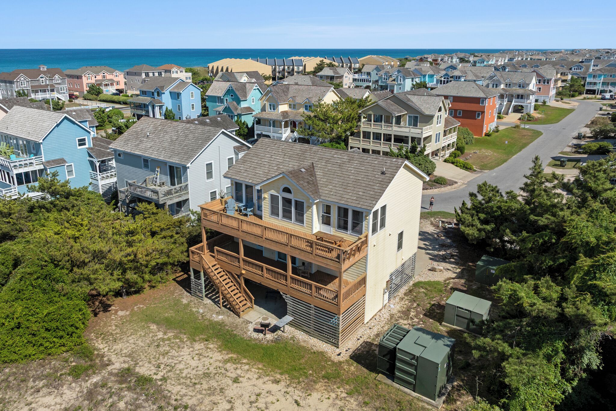 A coastal residential area with houses featuring balconies and a view of the ocean.