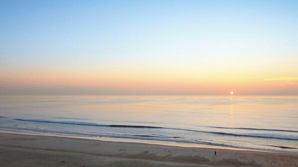 Experience the tranquility of a serene beach with gentle waves lapping at the shore.