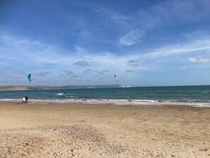 A beach with a clear sky and calm sea.