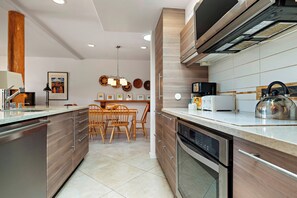 Enjoy cooking in this well-equipped kitchen with a dishwasher, stainless steel oven, and dining area.