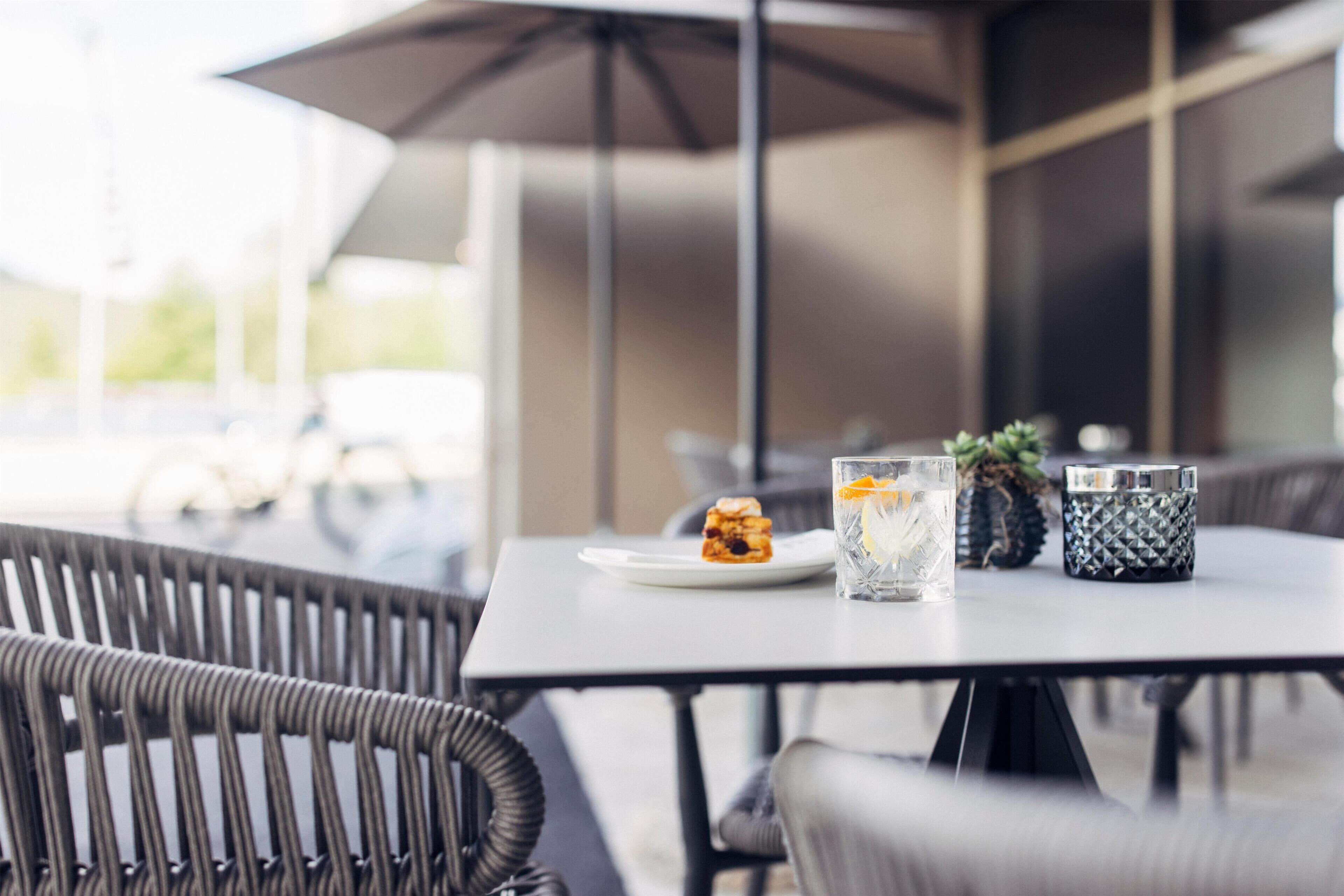 A table with a plate of food, a glass of water, and a decorative item.