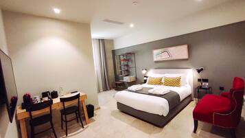 Deluxe Room | Minibar, in-room safe, desk, iron/ironing board