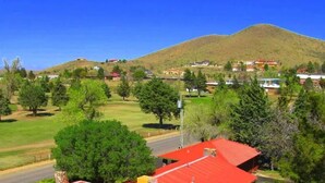 A residential area with houses, a road, and a hill in the background. - Honey's Suite at The Sage Guesthouse formerly the 19th Hole (Alpine)
