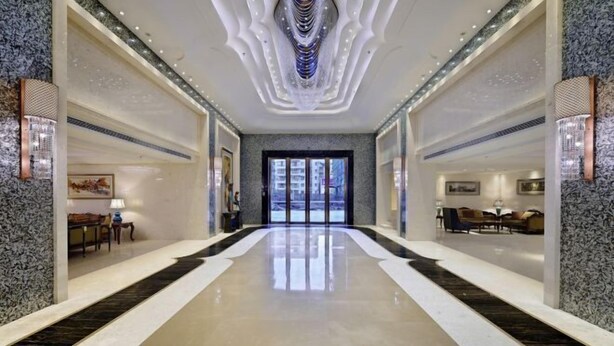 A spacious lobby with a polished floor, a central chandelier, and a view of the outside through a large door. - Count Diamond Hotel (Longli)