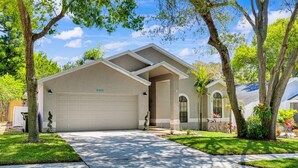 A single-story house with a garage, a front porch, and a well-maintained lawn. - Palm harbor/Crystal Beach 3/2 W Heated pool & Spa (Palm Harbor)