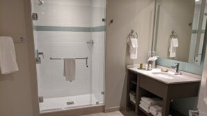 A modern bathroom with a glass-enclosed shower, a sink, and a mirror. - Luxury 2 Bedroom unit in beachfront Myrtle Beach resort Sleeps 8 (Myrtle Beach)