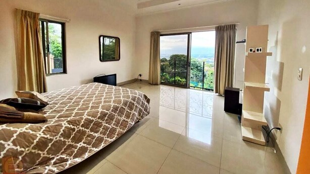 A spacious bedroom with a large bed, a wardrobe, and a view of the outdoors. - Palace of Dreams, Ultra-Modern Spanish Estate, Spectacular Views.  Hot Springs. (San Antonio)