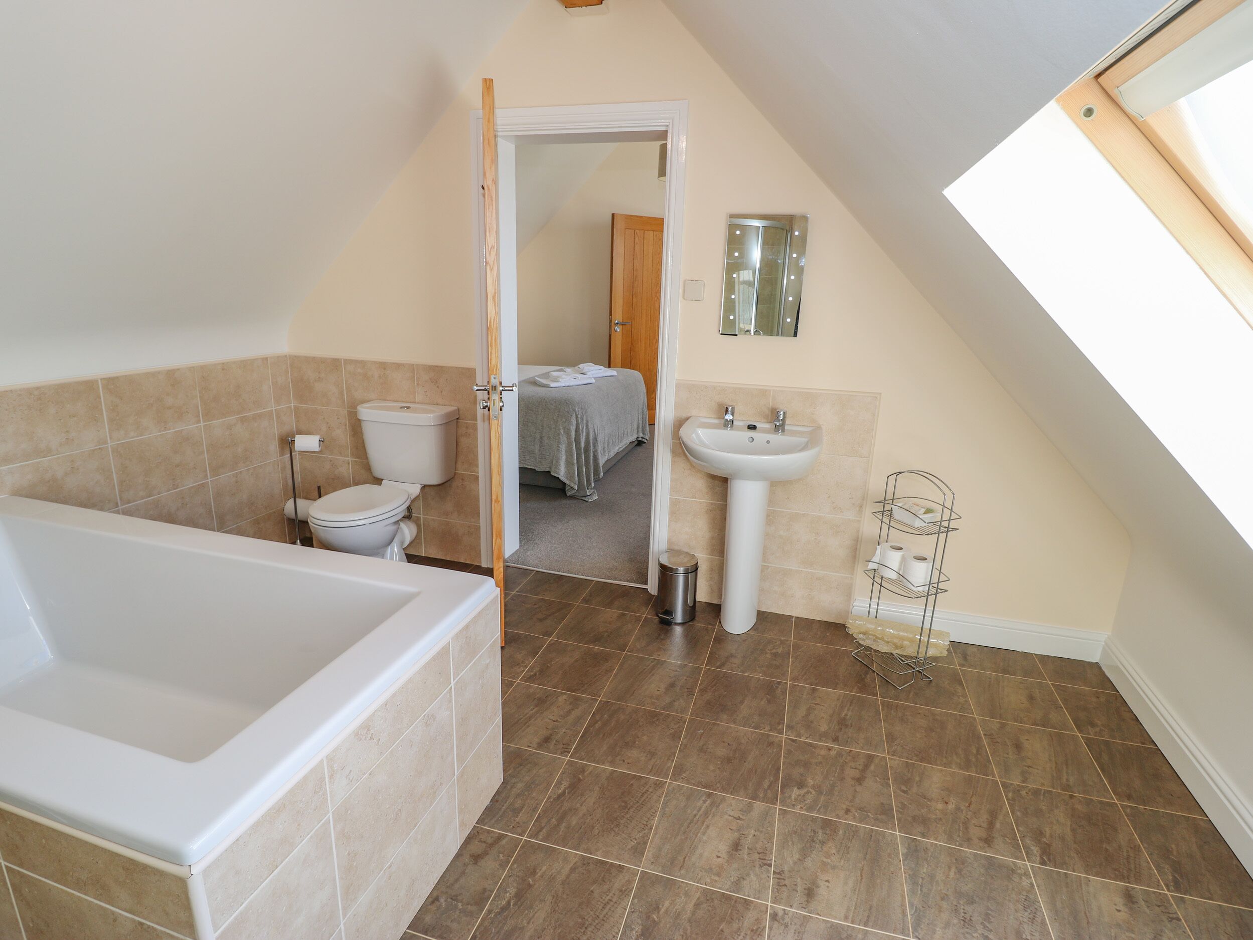 A bathroom with a bathtub, toilet, and sink.