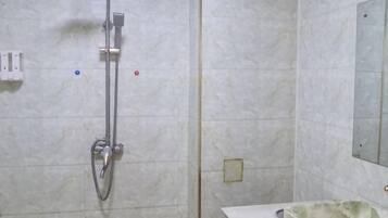 A bathroom with a shower, a sink, and a mirror.