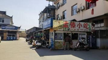 A street with shops and a food stall.