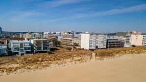 A coastal area with sandy beach and buildings in the background. - 1 Bedroom, Sleeps 4, Balcony w/ Ocean View (Ocean City)