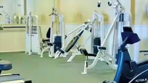 A gym with various exercise machines, including a treadmill and weight machines. - Beautiful beach condo for rent (Panama City beach)