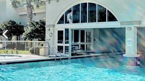 A swimming pool with a clear view of the poolside area, including a pool ladder and a 'KEEP OFF' sign. - Beautiful beach condo for rent (Panama City beach)