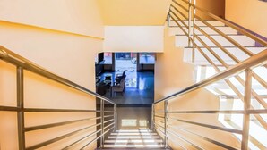 A staircase with metal railings leading to a lower level. - Vaccinated Staff - OYO 847 Cote D' Azure (Las Pinas)