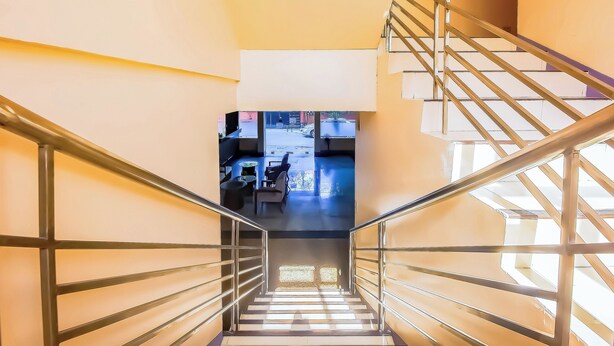 A staircase with metal railings leading to a lower level. - Vaccinated Staff - OYO 847 Cote D' Azure (Las Pinas)