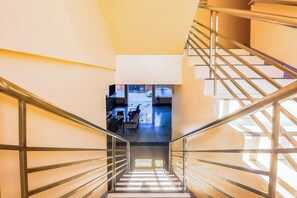 A staircase with metal railings leading to a lower level. - Vaccinated Staff - OYO 847 Cote D' Azure (Las Pinas)