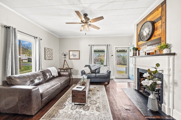 Cozy living room built in 1910 features leather furniture and gas fireplace.