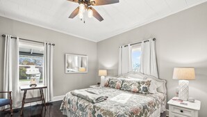 A bedroom with a bed, nightstands, a ceiling fan, and a window with curtains. - Clayton's 1910, Completely Restored Mill House, business-friendly weekday rates (Graham)