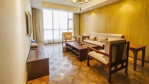 A hotel room with a sofa, armchairs, a coffee table, a desk, and a chandelier. - Qinyuan Zhixuan Hot Spring Hotel (Sanyuan)