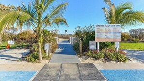A beach bar and grill entrance with palm trees and a clear sky. - Oceanfront 2 Bed/2 Bath, Sleeps 6, Pools, Gym, Etc (Ocean City)