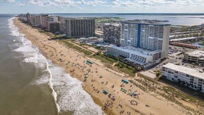 A coastal hotel with multiple buildings, a sandy beach, and a view of the ocean. - Oceanfront 2 Bed/2 Bath, Sleeps 6, Pools, Gym, Etc (Ocean City)
