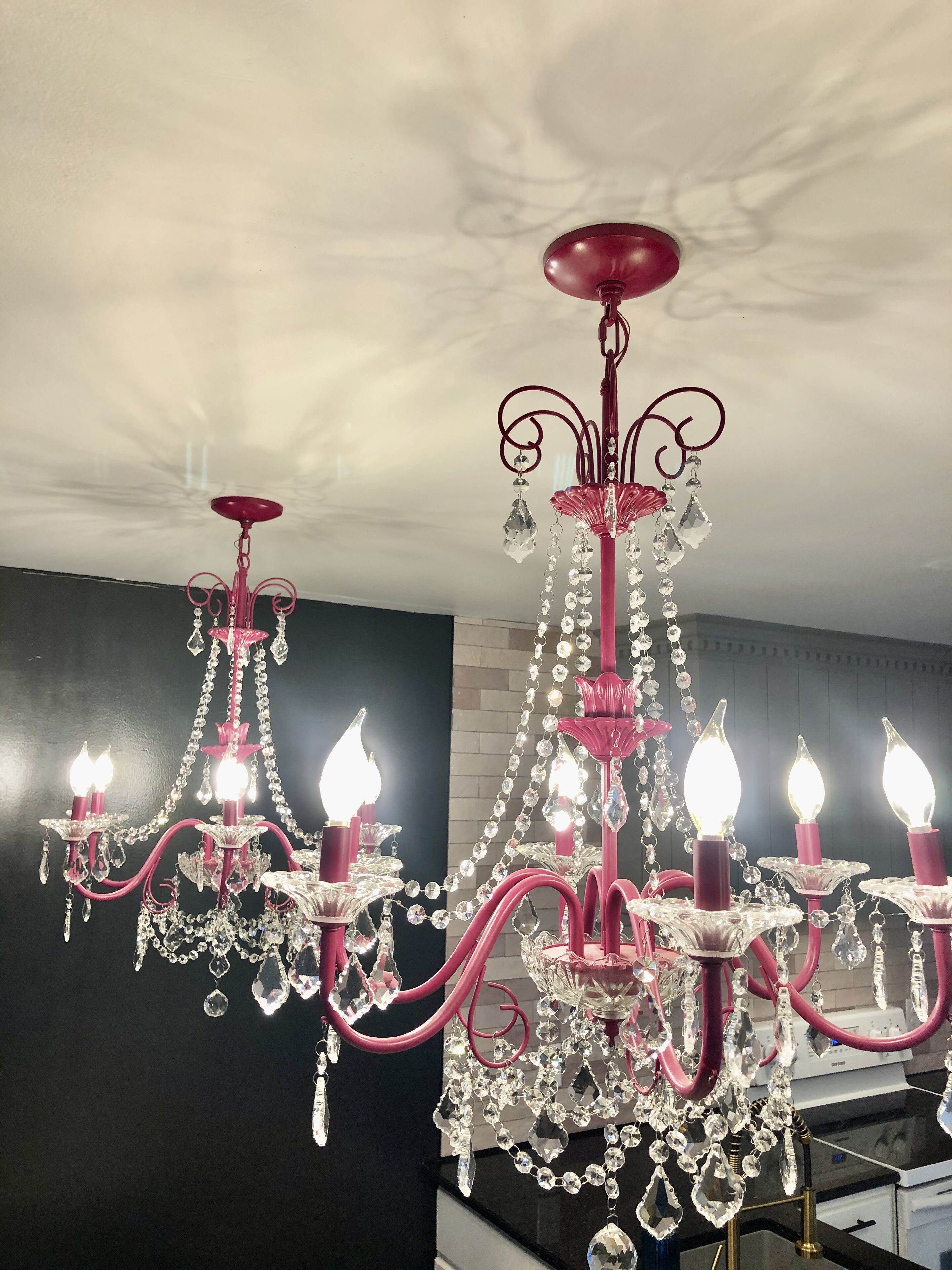 A chandelier with multiple candle-like lights and crystal decorations.
