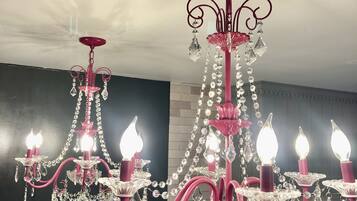 A chandelier with multiple candle-like lights and crystal decorations.
