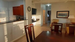 A modern apartment with a kitchen, dining area, and living room.