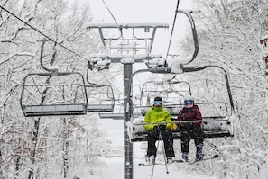 A ski lift with two skiers in bright jackets. - Devils Lake, hiking & Dells near peaceful retreat (Merrimac)