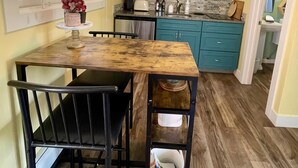 A kitchen with teal cabinets, a wooden table, and a black chair. - Located directly on the Crystal River (Redstone)