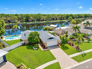 Aerial side view of our wonderful property what showcases our stunning heated pool, and beautiful driveway and our gorgeous fenced backyard. If you are interested in our property, send us an inquiry now!