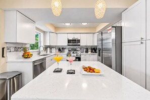 Large kitchen island provides the perfect gathering spot for meals, drinks, and conversation. - NEW Heated Salt Pool & Spa on Waterfront Canal (Tampa)
