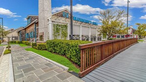 A restaurant with outdoor seating and a wooden deck.