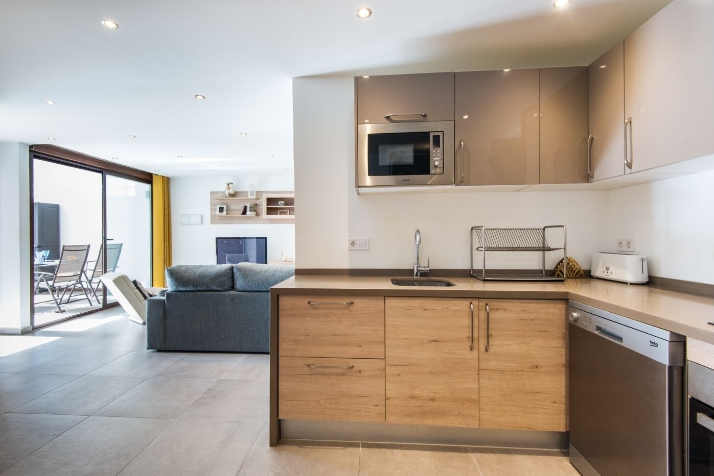 A modern kitchen with a built-in microwave, a dishwasher, and a toaster.