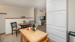 A compact living space with a dining area, a kitchenette, and a television. - Are you traveling to Rochester? Be our guest!!  (Rochester)