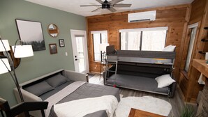 A compact room with a bunk bed, a sofa, a desk, and a ceiling fan. - Mountain Adventures with heated pool near Pittsburgh, State Parks, Falling Water (Champion)