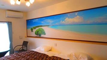 A hotel room with a bed, a large painting of a beach, a chair, and a ceiling light fixture.