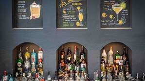 A bar area with three chalkboard signs listing cocktail recipes. - Seto Ghar Hotel Pvt. Ltd. (Kathmandu)