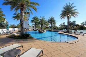 A pool area with lounge chairs, palm trees, and a clear blue sky. - Golf Cart & 6 Bikes! Bike to the Beach & Pool! Monthly Snow-Bird Rates! - Dragon Fly's Nest on 30A (Santa Rosa Beach)
