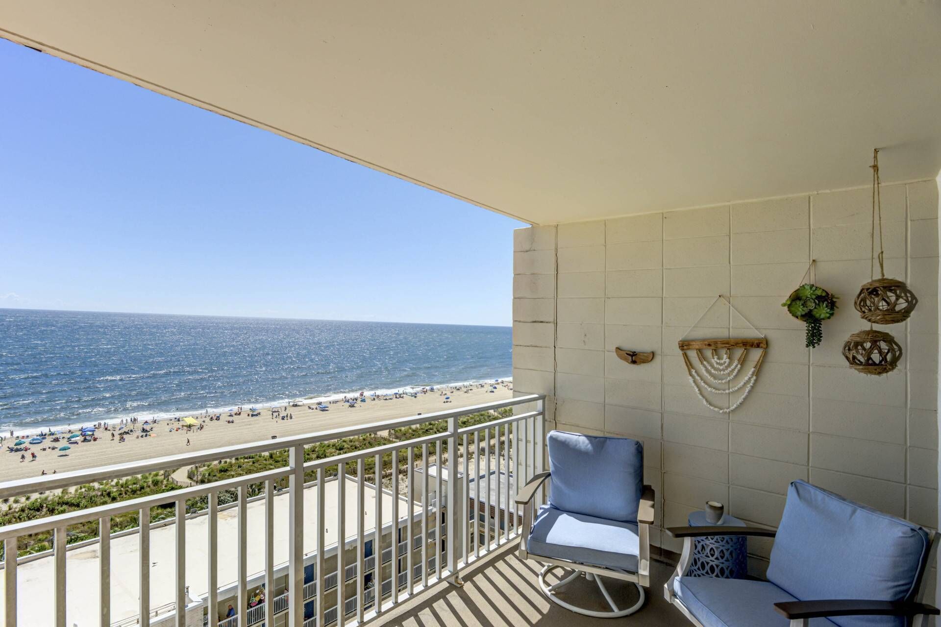 Oceanfront balcony with panoramic Atlantic views from your private coastal retreat. Direct beach access, relaxing lounge seating, and sunrise vistas.