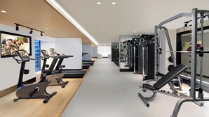 A gym with exercise equipment, including treadmills and weight machines. - Citadines Gaoxin Chengdu (Chengdu)