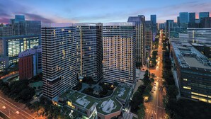 A high-rise building complex with multiple floors, large windows, and a central courtyard. - Citadines Gaoxin Chengdu (Chengdu)