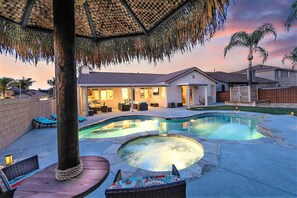 A backyard with a swimming pool, lounge chairs, and a covered seating area. - Wine Country Oasis Retreat - Close to wineries (Winchester)