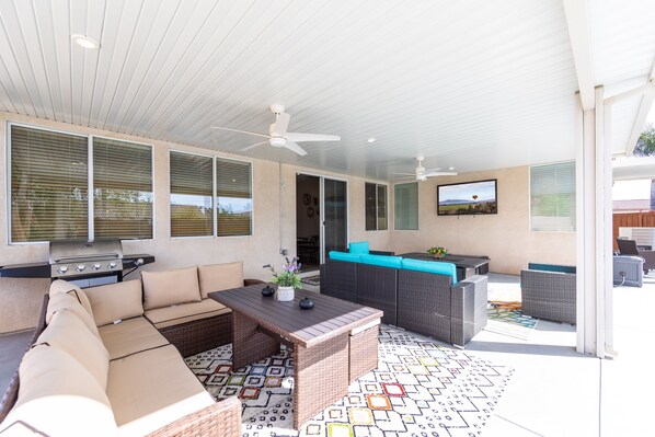 An outdoor patio with a sofa, table, and chairs, a grill, and a TV. - Wine Country Oasis Retreat - Close to wineries (Winchester)