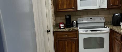 Microwave, dishwasher, coffee/tea maker, cookware/dishes/utensils