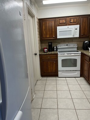 Microwave, dishwasher, coffee/tea maker, cookware/dishes/utensils