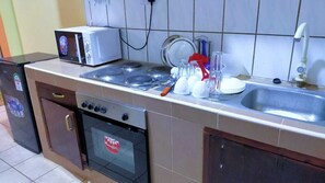 Family House | Private kitchen | Fridge, microwave, cookware/dishes/utensils, dining tables - Stay.Plus Mtwapa Holiday Home (Mtwapa)