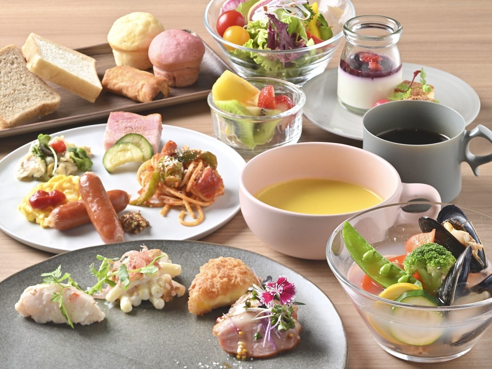 A variety of dishes including pasta, seafood, and bread, suggesting a diverse meal selection.
